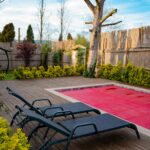 Serene outdoor area with lounge chairs by a small pool on a wooden deck.